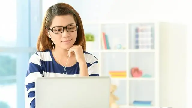 NEVEREST eEducation Frau mit Brille sitzt vor ihrem Laptop